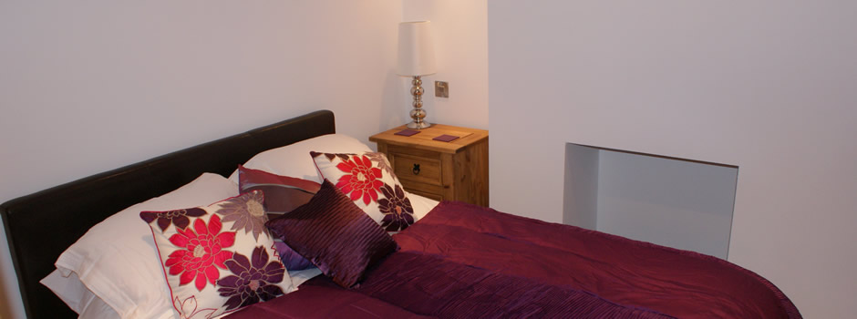 Bedroom One within the Penny Black Apartment